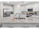 Kitchen features stainless steel appliances, white cabinets, and granite countertops with a deep sink at 5105 Sylas Jax Ave, Winter Haven, FL 33884