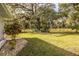 Spacious backyard with a large oak tree and a well-manicured lawn at 561 Cameo Dr, Lakeland, FL 33803