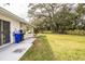 Large backyard with grassy lawn and mature trees at 561 Cameo Dr, Lakeland, FL 33803