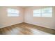 A cozy bedroom showcases wood-look floors and natural light through the window at 561 Cameo Dr, Lakeland, FL 33803