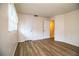 Bedroom featuring wood-look floors and two doors leading to closets and bathroom at 561 Cameo Dr, Lakeland, FL 33803