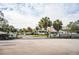 The Villas community entrance with palm trees and lush landscaping at 561 Cameo Dr, Lakeland, FL 33803