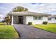White single story home with carport and green landscaping at 561 Cameo Dr, Lakeland, FL 33803