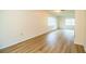 Bright, open living room with wood-look flooring and neutral walls, illuminated by natural light at 561 Cameo Dr, Lakeland, FL 33803