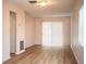The large living room features sliding glass doors and wood-look floors throughout at 561 Cameo Dr, Lakeland, FL 33803