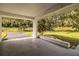 Covered outdoor patio offering a peaceful view of the greenery and landscaped backyard at 561 Cameo Dr, Lakeland, FL 33803