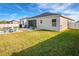 Large backyard with grassy lawn, fire pit, and patio furniture at 185 St Thomas Dr, Mulberry, FL 33860