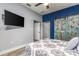 Bedroom with a rustic barn door and TV at 185 St Thomas Dr, Mulberry, FL 33860