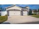 Charming single-Gathering home featuring a two-car garage and well-maintained landscaping at 185 St Thomas Dr, Mulberry, FL 33860