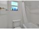Clean bathroom with shower/tub combo and white tile at 3107 Valley High Dr, Lakeland, FL 33813