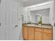 Bathroom with wood vanity and granite countertop at 3107 Valley High Dr, Lakeland, FL 33813