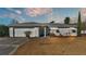 White single-story house with a two-car garage and well-maintained lawn at 3107 Valley High Dr, Lakeland, FL 33813