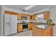 Kitchen boasts wood cabinets, granite countertops, and stainless steel appliances at 3107 Valley High Dr, Lakeland, FL 33813