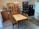 Bright dining room featuring a chandelier, dark cabinets and gray wood-look flooring at 3604 Julius Estates Blvd, Winter Haven, FL 33881