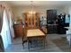 Bright dining room with chandelier, dark cabinets, and gray wood-look flooring at 3604 Julius Estates Blvd, Winter Haven, FL 33881