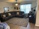 Spacious living room with ceiling fan, sectional sofa, and stylish patterned rug at 3604 Julius Estates Blvd, Winter Haven, FL 33881