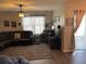 Inviting living room featuring a ceiling fan, large sectional sofa, and sliding glass doors at 3604 Julius Estates Blvd, Winter Haven, FL 33881