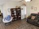 Comfortable living room with dark wood bookshelf, plush chair, and reclining sofa at 3604 Julius Estates Blvd, Winter Haven, FL 33881