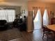 Cozy living room with a brown leather sofa, plush rug, and sliding glass doors to patio at 3604 Julius Estates Blvd, Winter Haven, FL 33881