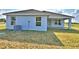Well-kept backyard featuring a bright blue home exterior and a spacious, sunny lawn area at 4036 Tullamore Ln, Auburndale, FL 33823