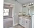 Bathroom featuring double sinks and view into bedroom at 4036 Tullamore Ln, Auburndale, FL 33823