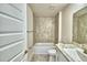Bright bathroom featuring a tub with tile surround and a vanity at 4036 Tullamore Ln, Auburndale, FL 33823