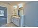 Bathroom featuring double sink vanity, granite countertop and tile flooring at 4036 Tullamore Ln, Auburndale, FL 33823