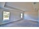 Spacious bedroom with carpeted floor and tray ceiling at 4036 Tullamore Ln, Auburndale, FL 33823