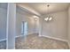 Open dining room features neutral walls, tile floors, and a modern chandelier at 4036 Tullamore Ln, Auburndale, FL 33823