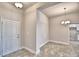 Bright entryway features neutral walls, tile floors, and a contemporary light fixture over the adjacent dining area at 4036 Tullamore Ln, Auburndale, FL 33823