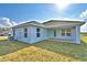 Rear exterior view of house with lawn at 4036 Tullamore Ln, Auburndale, FL 33823