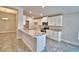 Bright kitchen features white cabinetry, stone countertops, stainless appliances, and an island at 4036 Tullamore Ln, Auburndale, FL 33823
