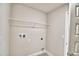 Laundry room offers a single shelf with connections for washer and dryer at 4036 Tullamore Ln, Auburndale, FL 33823