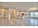 Expansive living area flows seamlessly into the kitchen, featuring modern finishes and lots of natural light at 4036 Tullamore Ln, Auburndale, FL 33823