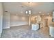 Open-concept design featuring modern appliances, a center island, tile floors, and a view of the living area at 4036 Tullamore Ln, Auburndale, FL 33823