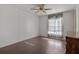 Bright bedroom with wood-look floors, ceiling fan, and sheer curtains at 4903 Deerwood Dr, Lakeland, FL 33810