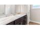 Bathroom featuring a marble vanity top, a mirror, and a white tiled wall at 715 Sw 77Th Cir, Ocala, FL 34474