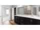 Bright bathroom featuring a marble countertop with double sinks and a mirror at 715 Sw 77Th Cir, Ocala, FL 34474