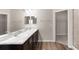 Bright bathroom featuring a marble countertop with double sinks and a mirror at 715 Sw 77Th Cir, Ocala, FL 34474
