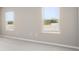 Bright bedroom featuring plush carpeting, neutral paint and two large windows at 715 Sw 77Th Cir, Ocala, FL 34474