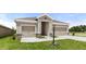 A charming home featuring a welcoming entrance, attached two-car garage, and well-maintained landscaping at 715 Sw 77Th Cir, Ocala, FL 34474