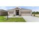 A charming two-story home featuring a welcoming entrance, attached two-car garage, and well-maintained landscaping at 715 Sw 77Th Cir, Ocala, FL 34474