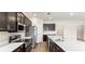 Modern kitchen with stainless steel appliances, dark cabinets, a large island, and hardwood floors at 715 Sw 77Th Cir, Ocala, FL 34474