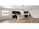 Modern kitchen with stainless steel appliances, dark cabinets, a large island, and hardwood floors at 715 Sw 77Th Cir, Ocala, FL 34474