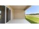 Covered patio with sliding glass doors overlooking the backyard at 715 Sw 77Th Cir, Ocala, FL 34474
