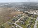 Expansive aerial view of a neighborhood showcasing modern homes and community spaces in a serene landscape at 1155 Towergate Cir, Lake Wales, FL 33853