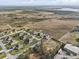 Expansive aerial view of the neighborhood, featuring homes and undeveloped land at 1155 Towergate Cir, Lake Wales, FL 33853