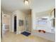 Bathroom features a walk-in shower, soaking tub, and a window for natural light at 1155 Towergate Cir, Lake Wales, FL 33853