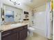 Functional bathroom with a granite vanity, shower-tub combo, and neutral decor at 1155 Towergate Cir, Lake Wales, FL 33853