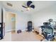 Well-lit bedroom with closet, light gray carpet, and unique ceiling fan at 1155 Towergate Cir, Lake Wales, FL 33853